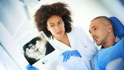 African American dentist“width=