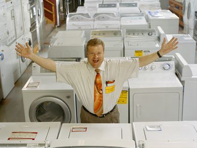 a salesman standing in an appliance showroom