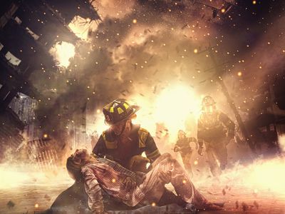 firefighter saving boy in burning building